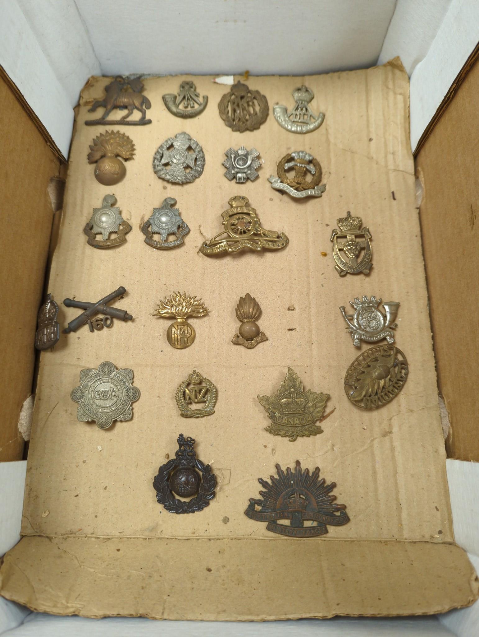 A group of British military cap badges and buttons, various commemorative medals and Pakistan General Service Medals